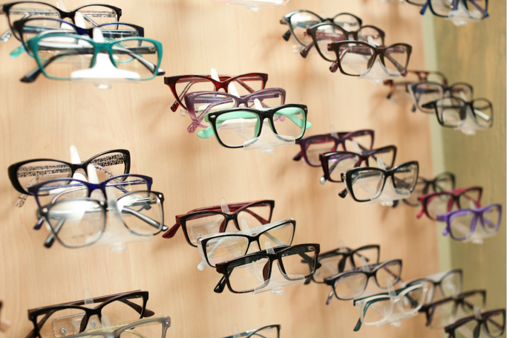 A wall display showcasing various styles and colors of eyeglasses.