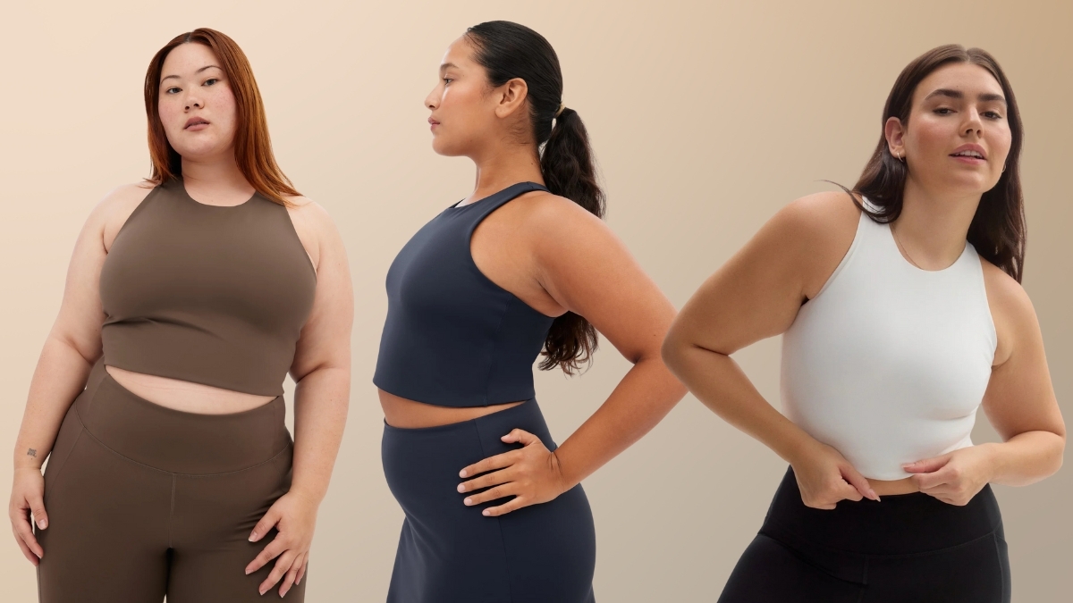 hree women of different body types wearing the Girlfriend Collective Dylan Tank Bra in brown, navy, and white, showcasing its inclusive sizing, high-neck design, and sustainable activewear style.