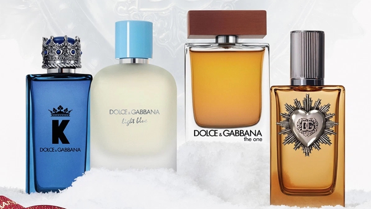 Dolce & Gabbana men’s fragrance lineup featuring K by D&G, Light Blue Pour Homme, The One for Men, and a gold D&G perfume bottle displayed on a snowy holiday backdrop