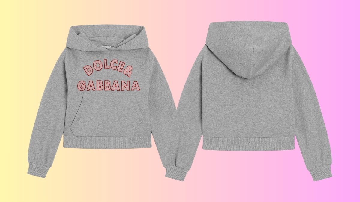 Grey Dolce & Gabbana children’s hoodie with red embroidered logo, shown from front and back on a pastel gradient background.